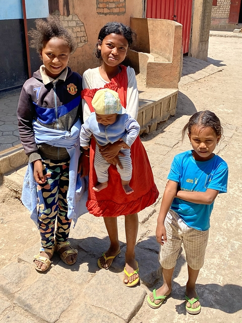Group of children standing on a pathway.