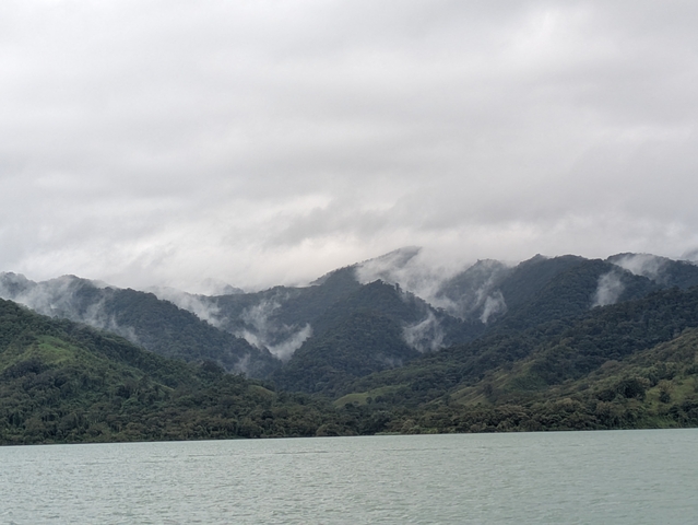 Cloudy mountain range above a body of water.