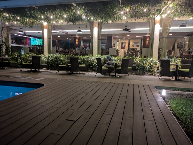       Patio restaurant setting adjacent to a pool.
  