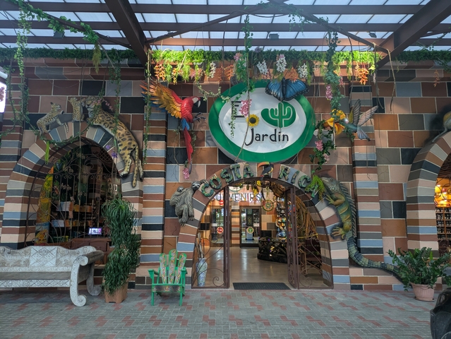 Decorative restaurant entrance with animals and foliage.