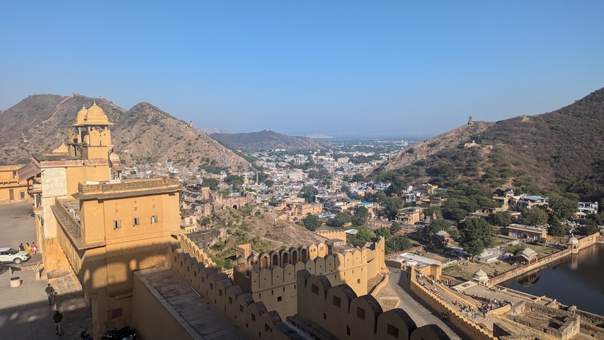       Panoramic view of a city with surrounding hills.
  