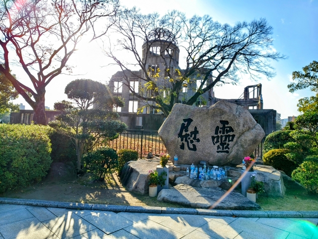       Memorial site with ruins in the background.
  