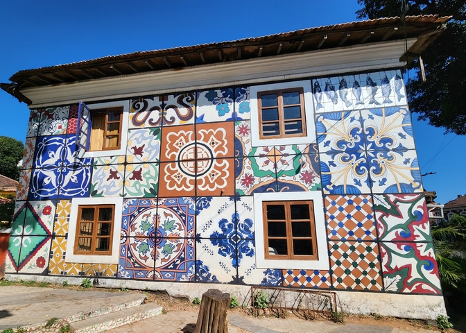 Building facade decorated with colorful tiles.