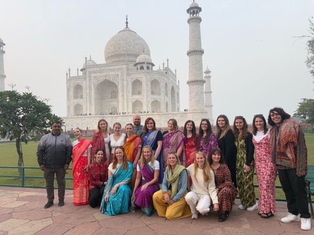       Large group of people in front of the Taj Mahal.
  