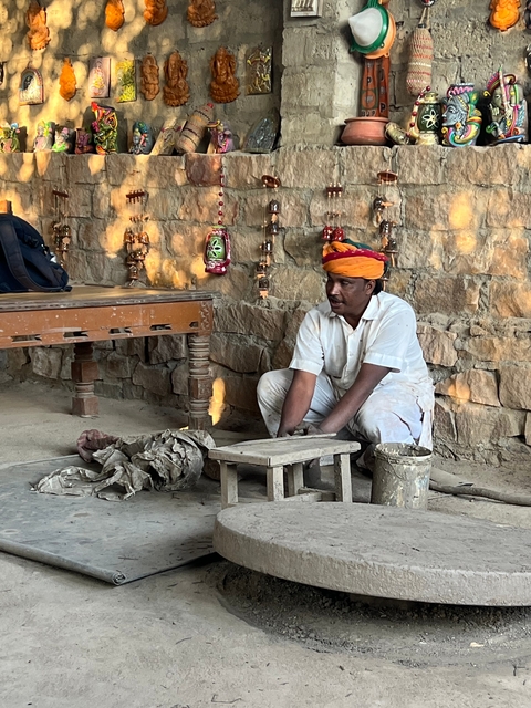       Man demonstrating pottery making.
  