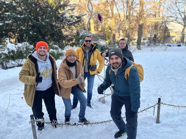 Group posing outside on a snow-covered ground.