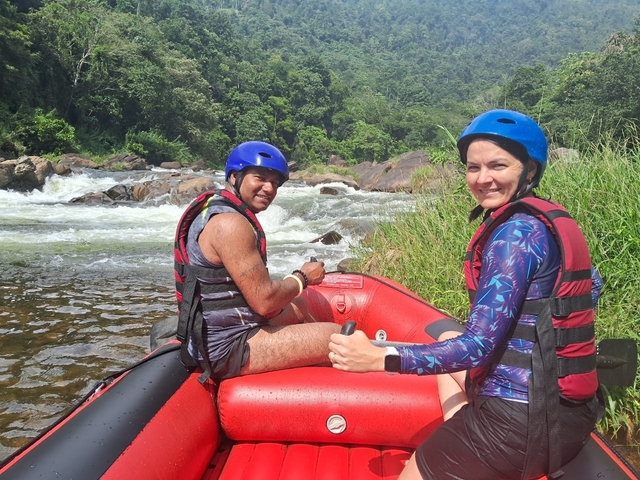 Two people rafting on a river.