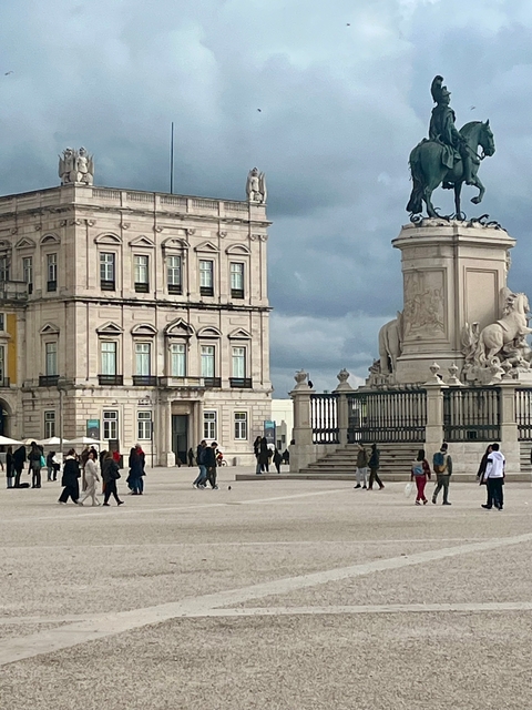       Square with historical buildings and a statue.
  