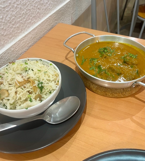       A dish with rice and curry.
  