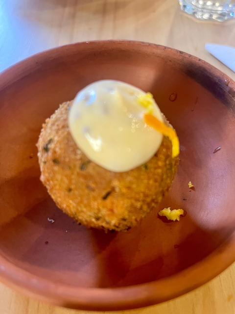       A close-up of a food item with sauce on top.
  