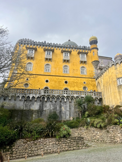       Close-up of a yellow palace building.
  
