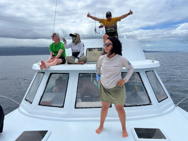       People enjoying a boat ride on the water with scenic views.
  