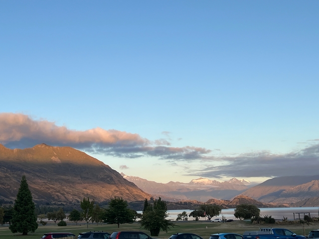       Panoramic view of a mountainous landscape under a clear sky.
  