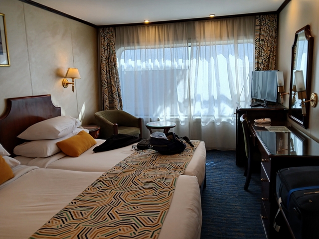Interior of a hotel room with two beds and modern decor.