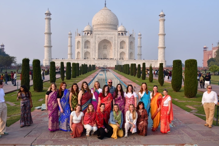       Group of people in front of the Taj Mahal.
  