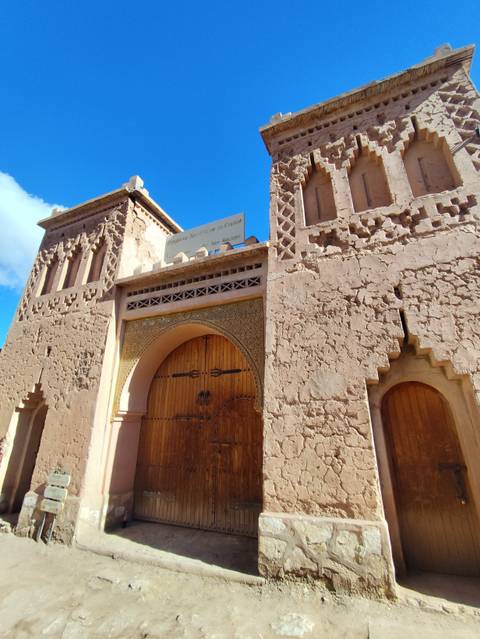       Traditional Moroccan building with detailed doorway.
  