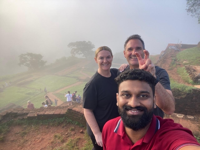 Selfie of three people on a misty morning on a hill.