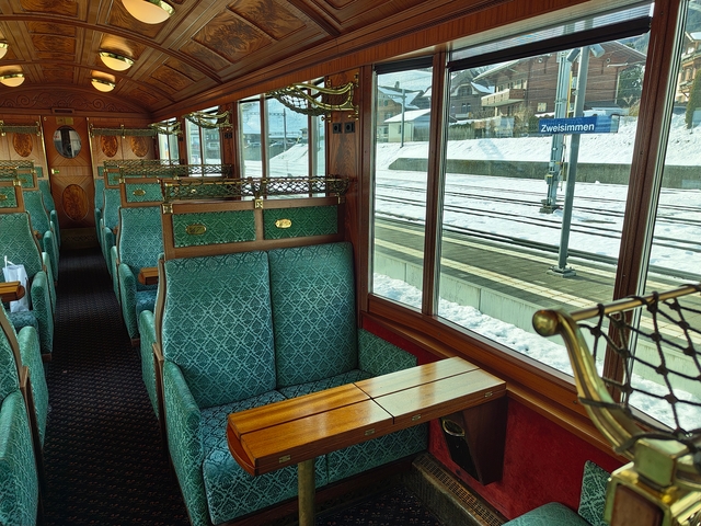       Interior of a vintage train looking out to snow-covered platform.
  