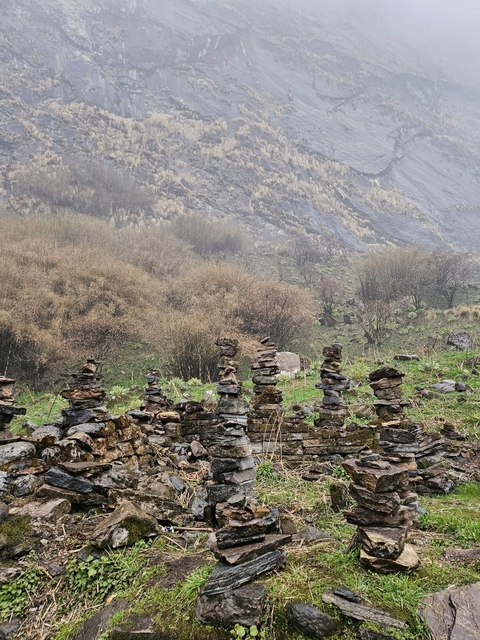Stone cairns in a mountainous landscape.