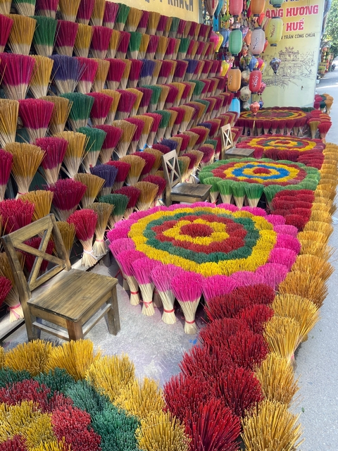 Colorful incense sticks arranged in geometric patterns.
