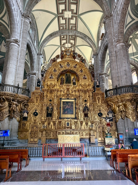Ornate golden altar inside a historic cathedral.