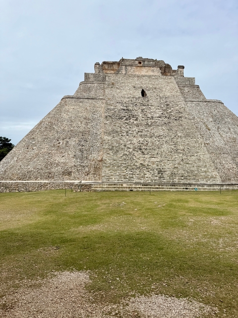 Ancient stone pyramid with a staircase leading to the top.