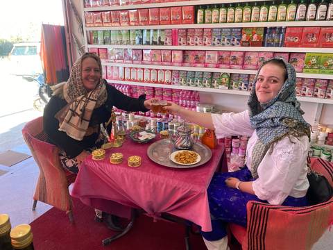 Two women enjoying tea in a shop.