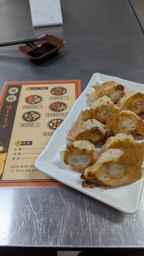       Plate of dumplings with a menu on the side.
  