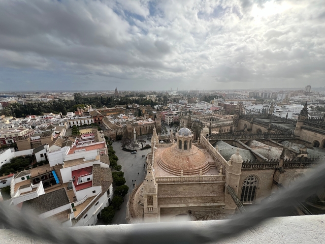 Aerial view of a city with historic buildings and a cathedral.