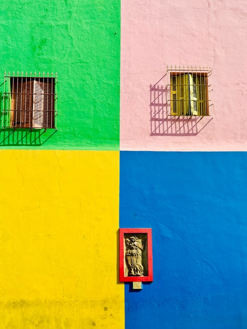 Colorful building facade with windows.
