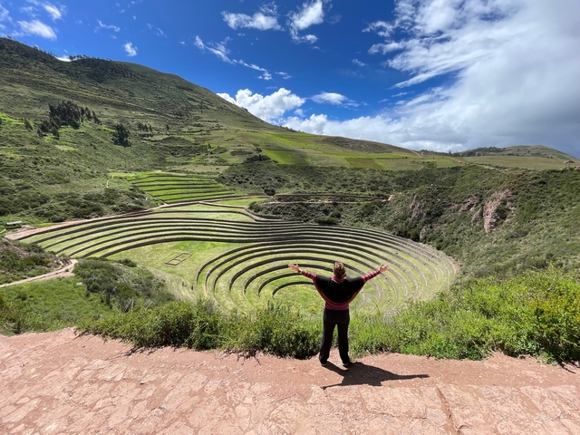       A person enjoying the view of the terraced circles of Moray.
  