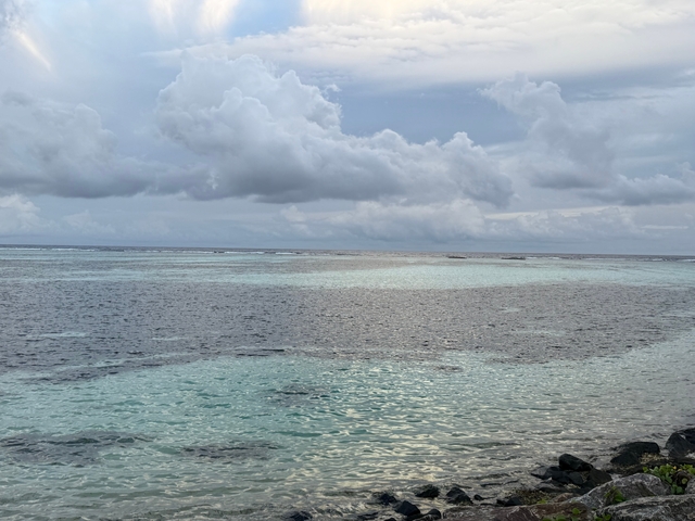       Calm ocean view with dark clouds gathering.
  