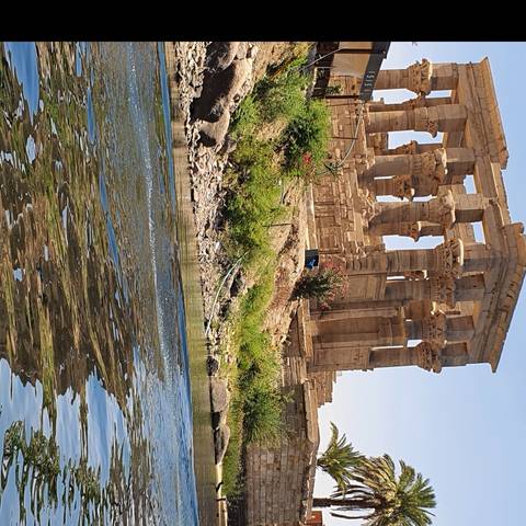       Ancient stone ruins next to a flowing river.
  