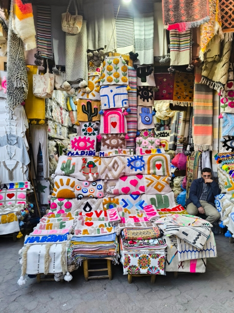 Colorful textiles displayed at a market stall.