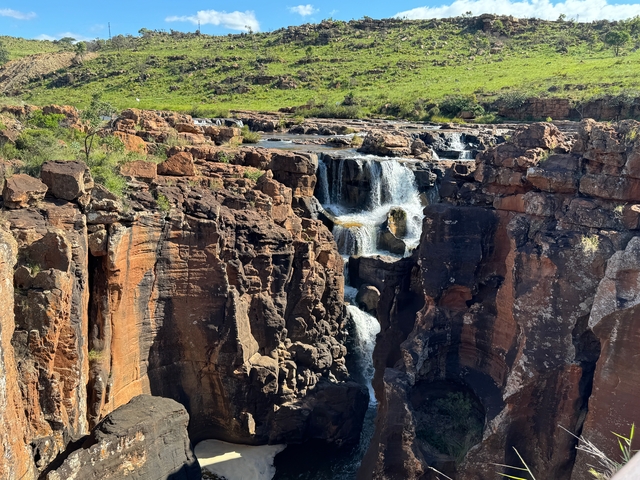       Waterfall cascading down rocky cliffs.
  
