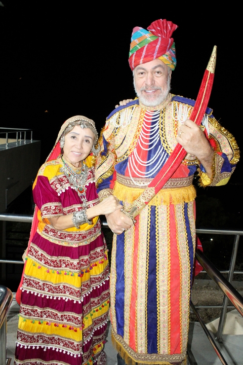       Couple in traditional attire at a cultural event.
  