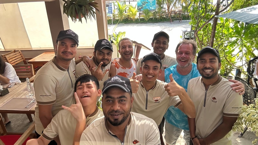 Group of people posing in an outdoor seating area.