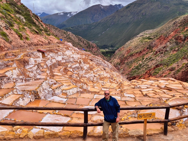 Person standing in front of the salt flats in the Sacred Valley.