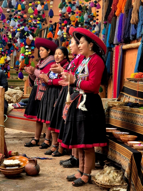 Local women in traditional clothing performing a cultural activity.