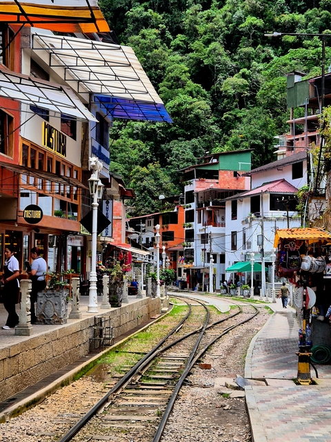 Colorful town buildings with mountains in the background.