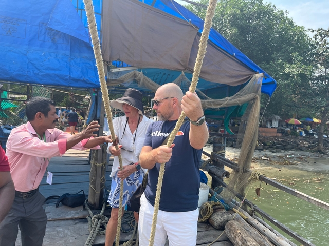 People interacting with a demonstration on a boat.