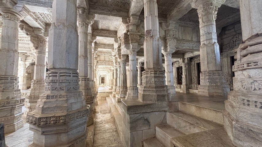       Intricately carved marble columns inside a temple.
  