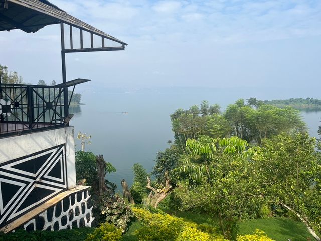 View of a lake surrounded by trees from a balcony