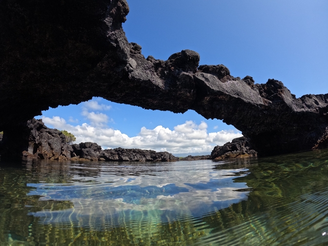 Natural stone arch over the water