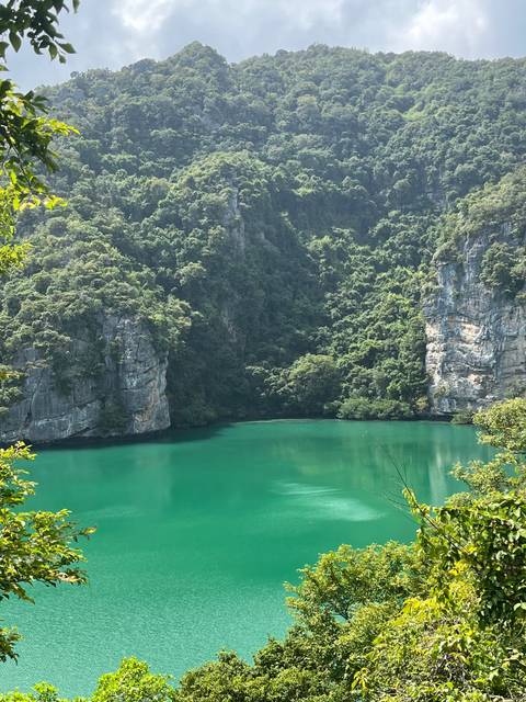 Green lagoon surrounded by cliffs