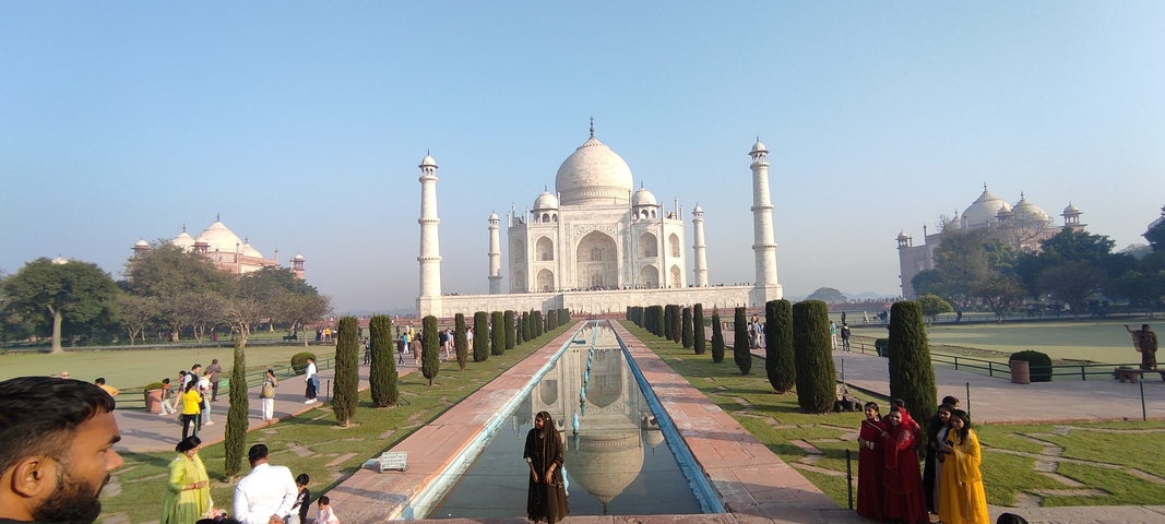 People visiting the Taj Mahal during the day.