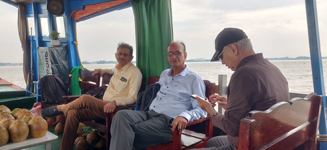Three men sitting on a boat.