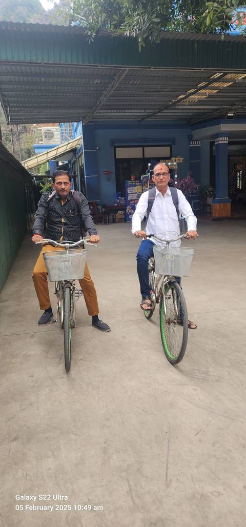Two men riding bicycles.