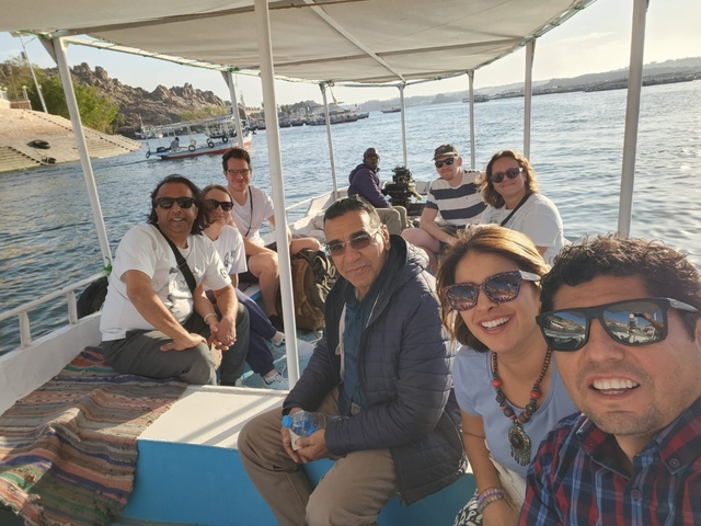Tourists on a boat ride on a bright day.