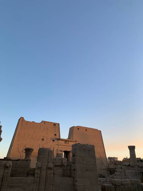 Ruins of an Egyptian temple with clear blue sky.